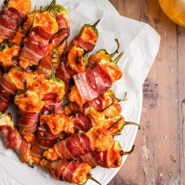Bacon-wrapped jalapeño poppers filled with melted cheese and baked until crispy.