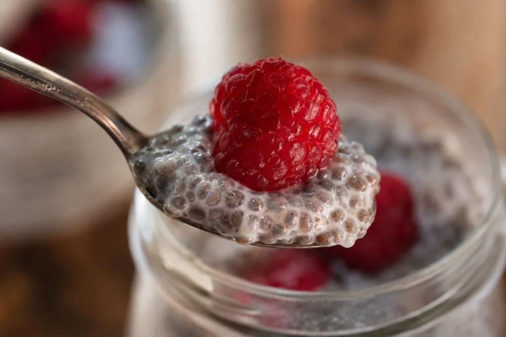 Chia Seed Pudding Recipe: Creamy 5 Ingredient No Cook 6 Single spoonful of homemade chia pudding with a raspberry on top