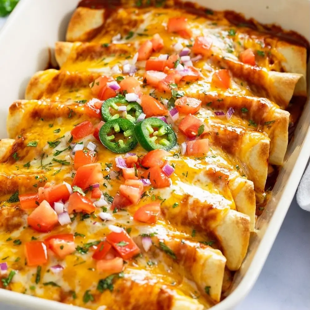 Chicken Enchiladas Recipe with Tender Filling and Red Sauce, 8 Steps 2 chicken enchiladas baked with tomato jalapeno topping