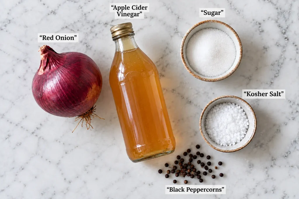 Ingredients for a quick pickled red onion recipe laid out on marble